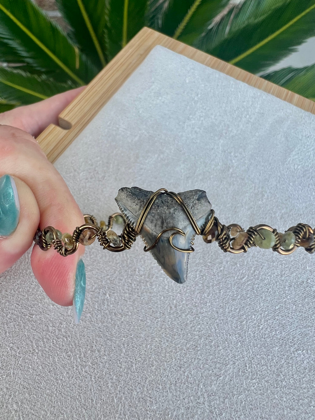 Shark tooth with green garnet gemstones, and bronze cuff bracelet